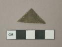 Metal alloy sheet fragment, triangular, heavily corroded, likely brass