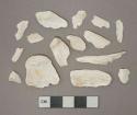 White unidentified shell fragments, heavily degraded