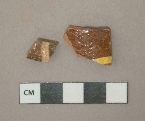 Yellow on red slip decorated redware vessel body fragments