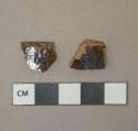 Mottled brown lead glazed redware vessel body and rim fragments