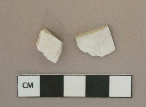 Undecorated white ironstone vessel body and rim fragments, white paste