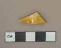 Yellow lead glazed earthenware vessel body fragment, slight brown mottling, buff paste, possible Staffordshire slipware