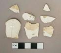 Undecorated whiteware vessel body and handle fragments, white paste