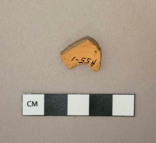 Unglazed redware vessel fragment, likely terracotta, possible flowerpot base