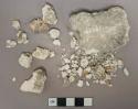 White mortar fragments, heavily degraded