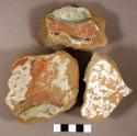 Plaster and unidentified paint fragments from debris