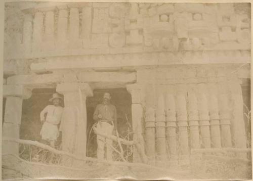 Two men, one on right possibly Augustus Le Plongeon, standing in galleries, detailed view of pillars, Palace of Sayil