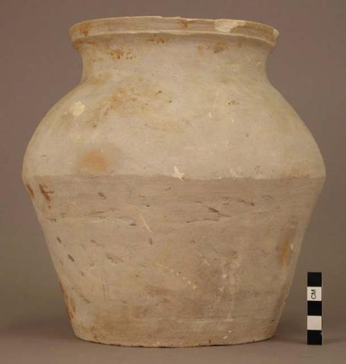 Grey ware urn - flaring rim; brown spots