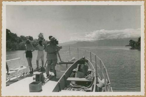 Chiriquí Lagoon, four people standing on bow or stern of boat