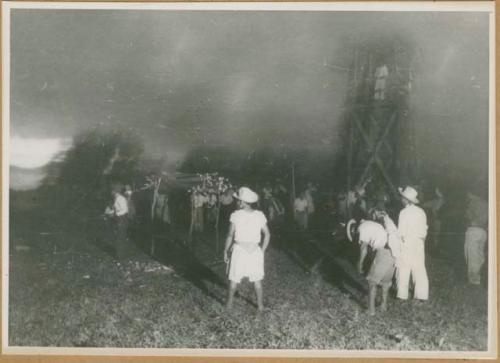 Ngobe-Bugle next to tower built for movie camera drinking at night