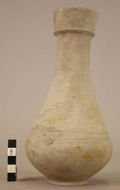 Bottle, pottery, closed inside of neck except for slits through the pottery seal