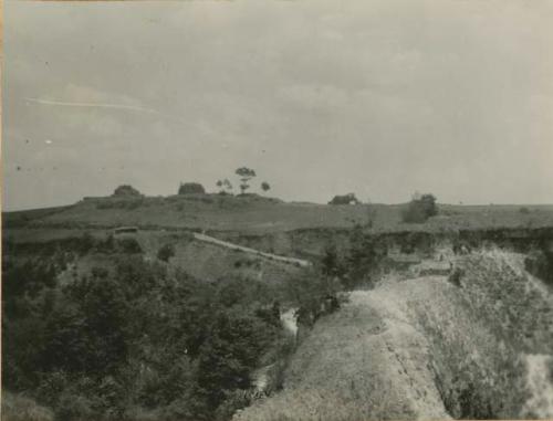 Terraced hill, with structures in background