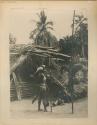 Man and woman in front of house