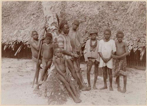 Group of boys in front of a thatched structure