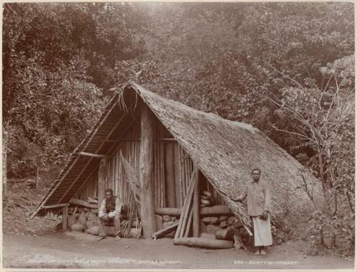 Man and woman in front of house