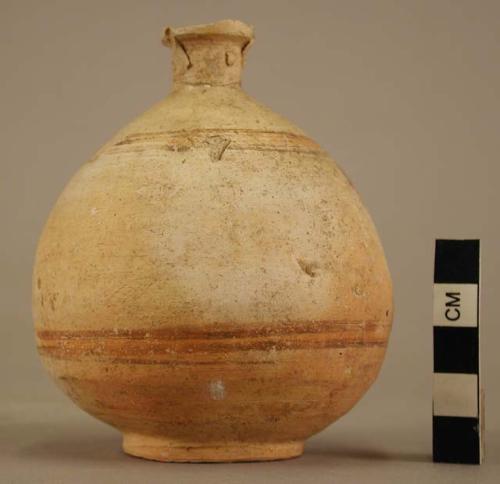 Small jug of thin white ware with yellow slip, two handles