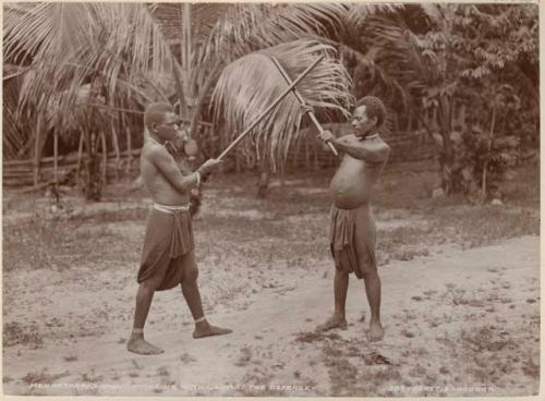 Two men fighting with clubs