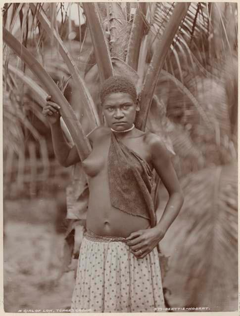 Girl standing in front of a palm