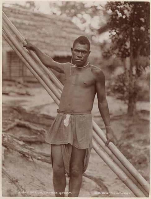 Man leaning against poles