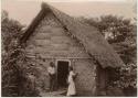 Man, woman and baby in front of house