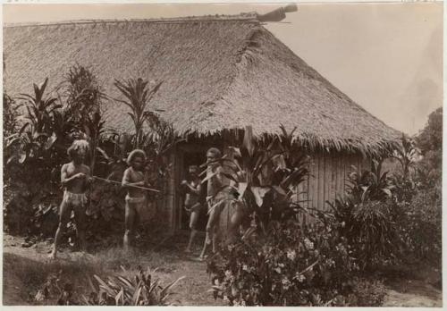 Group of men in front of a house