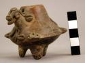 Chocolate ware miniature tripod with applique and incised motifs representing a