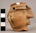 Human head effigy hollow miniature vessel; hair like bangs in front 2 holes at t