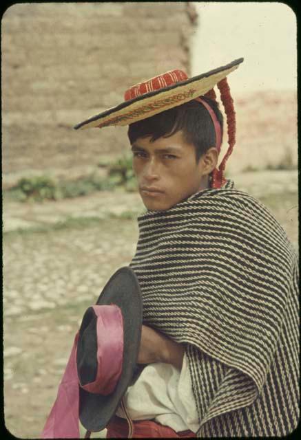 Huistan village, young man with two hats