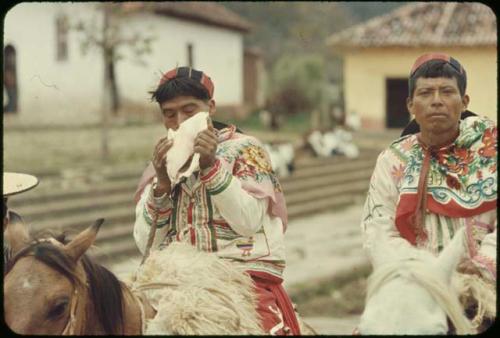 Huistan village, Carnaval rider pauses for refreshment