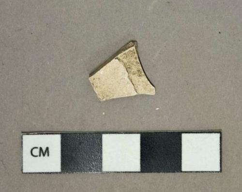 Undecorated earthenware vessel body fragment, glaze missing, white paste