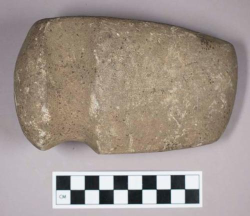 Ground stone, grooved axe with rounded end and flat base