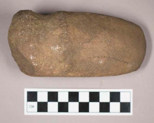 Ground stone, grooved axe with flat base and rounded end