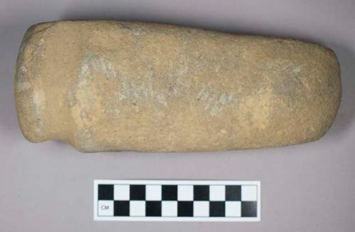 Ground stone, grooved axe with flat base and rounded end