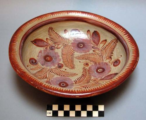 Bowl. white background with rust colored floral and fern design