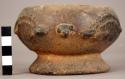 Unpainted pottery bowl - ring base, relief decoration in fom of birds