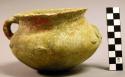 Complete pottery vessel: rounded base, constricted mouth with out-turned lip.  O