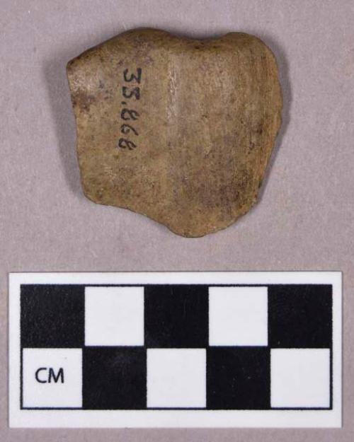 Ground stone, perforated stone fragment, possible bannerstone fragment