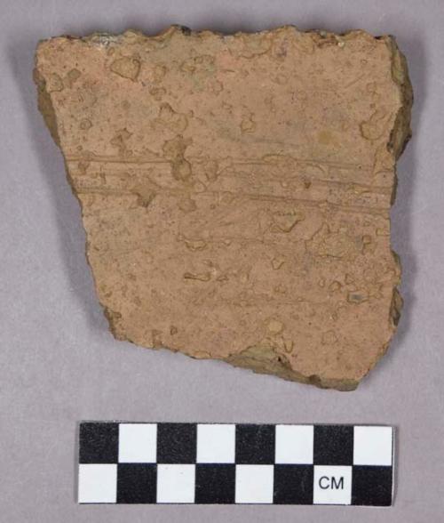 Ceramic, earthenware rim sherd, grit-tempered, incised rim and body