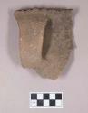 Ceramic, earthenware rim and handle sherd, partially cord-impressed, incised rim above handle, shell-tempered