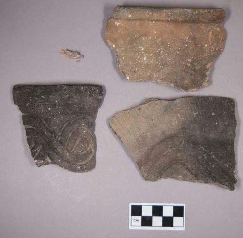 Ceramic, earthenware rim and body sherds, some undecorated, some incised with possible Ramie design, cord-impressed and incised with possible Ramie design, shell-tempered; chipped stone, grooved axe