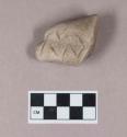 Ground stone, incised sculpture fragment, possible animal snout