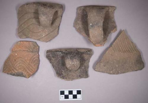 Ceramic, earthenware rim, handle, and body sherds, some undecorated, some incised, some with possible Ramie design, some cord-impressed, some punctate, some incised and cord-impressed, some incised and punctate, some with incised rim, some with punctate rim, shell-tempered