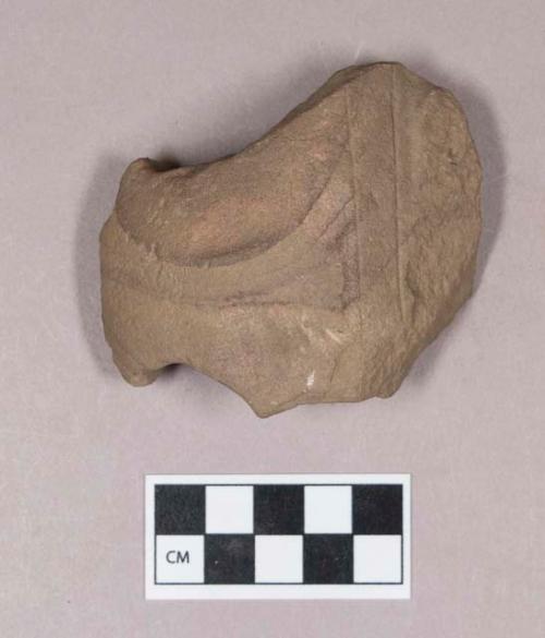 Ground stone, object fragment, drilled from both sides, incised