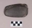 Worked coal object, flat, ovoid, chipped at one end