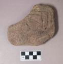 Ground stone, flat stone fragment, grooved on both sides, may be decorative or functional