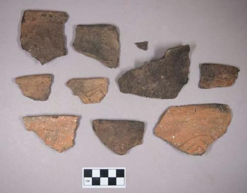 Ceramic, earthenware rim and body sherds, some incised, some incised and cord-impressed, some undecorated, shell-tempered