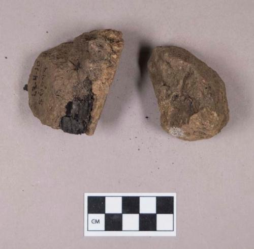 Soil fragments, possibly clay, with charcoal fragments embedded in them