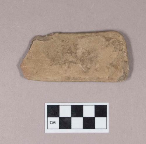 Ground stone, flat rectangular stone fragment, incised on both sides, possible bird image, one partial perforation