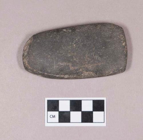 Ground stone, flat rectangular object, rounded at one end