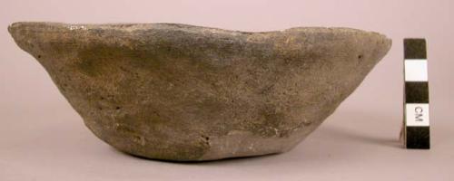 Bowl of coarse, black, semi-fired ware